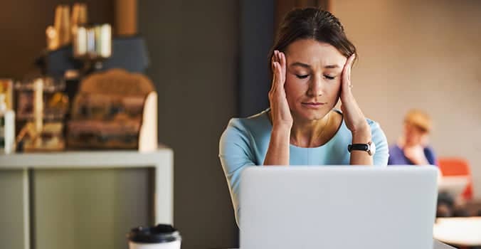 Woman holding her face while trying to find out how to recover an Excel file not saved